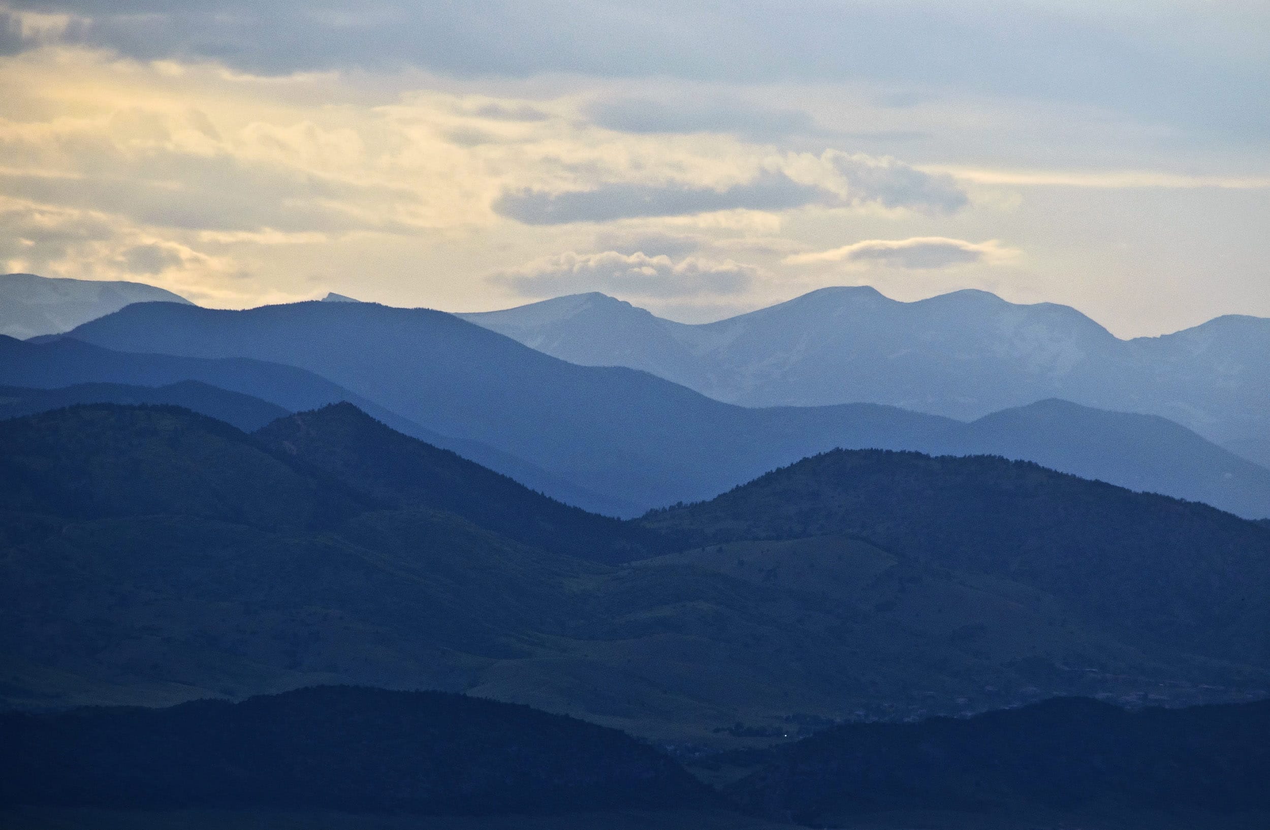 mountains with a few clouds in the sky